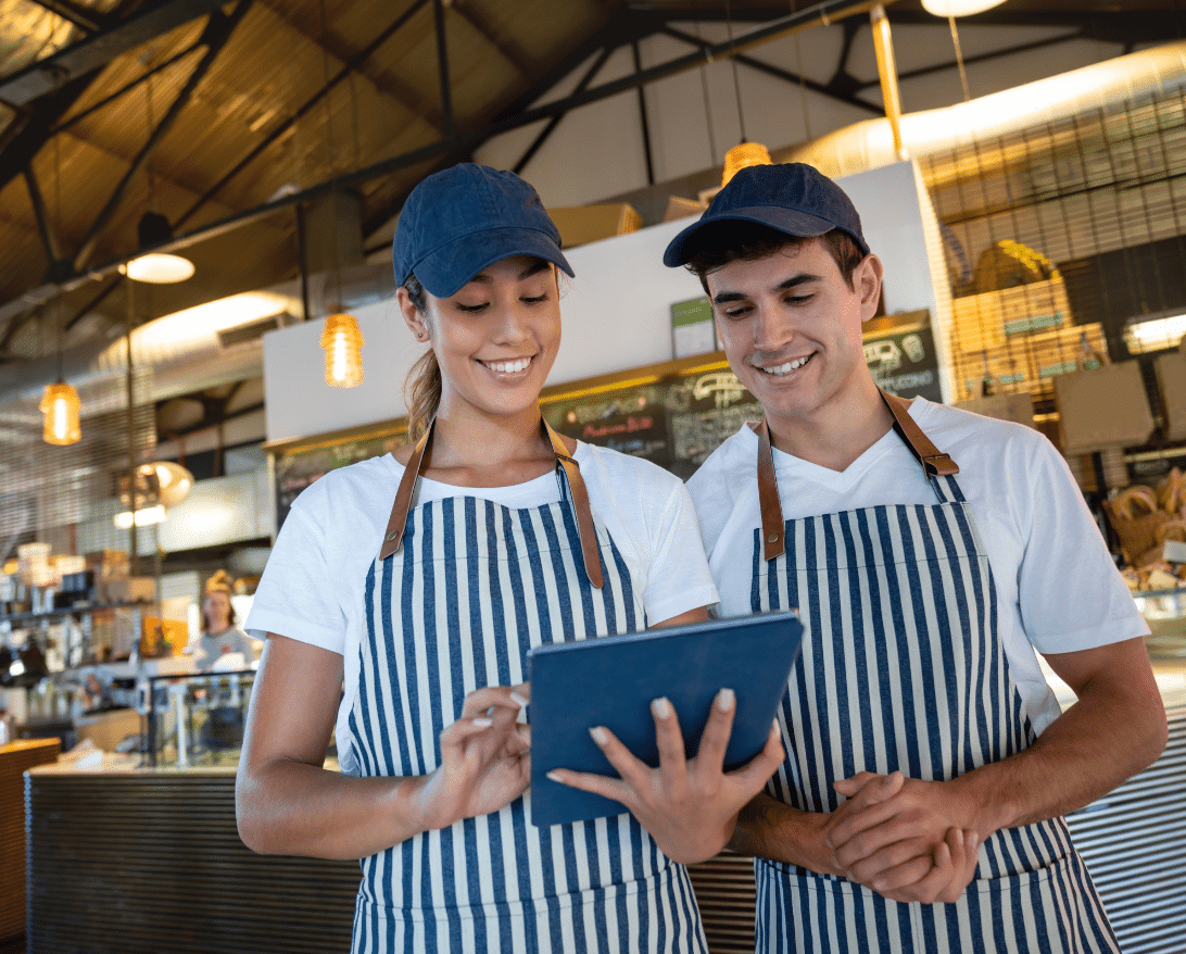 Employees look at a restaurant email marketing plan