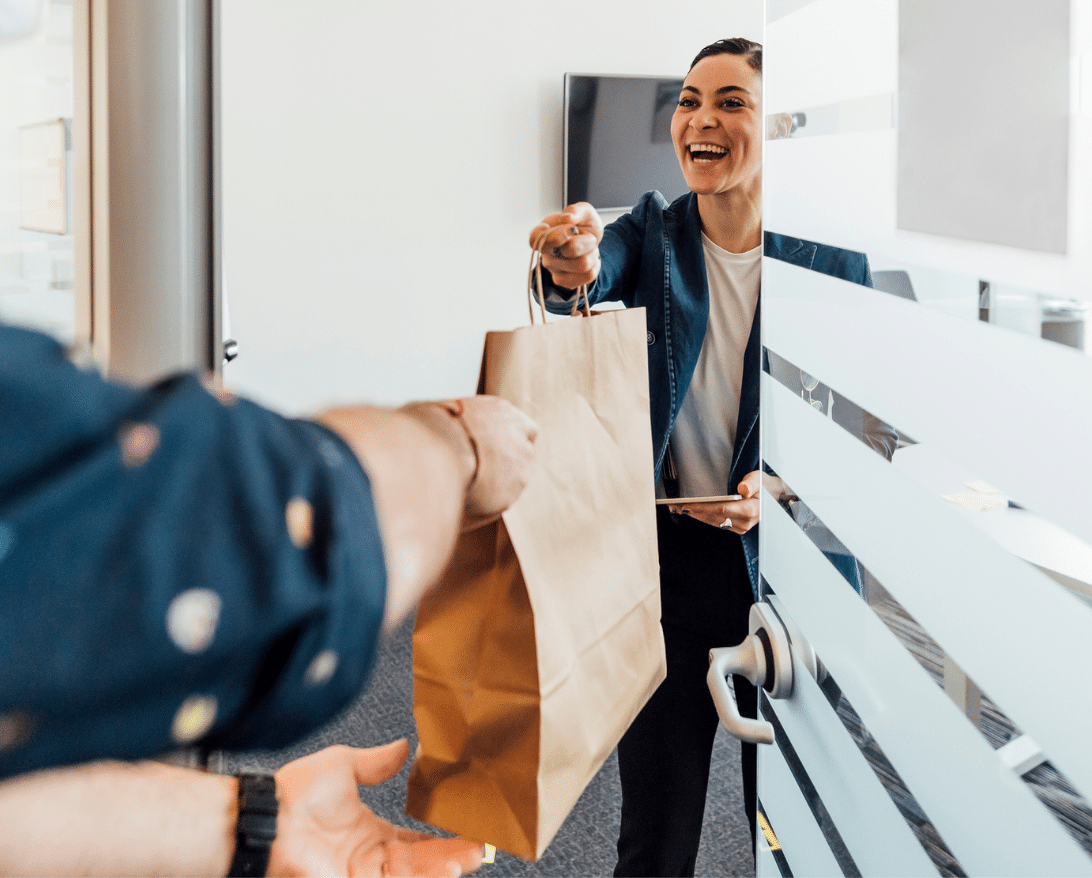 woman getting food delivery, increasing order completion rate