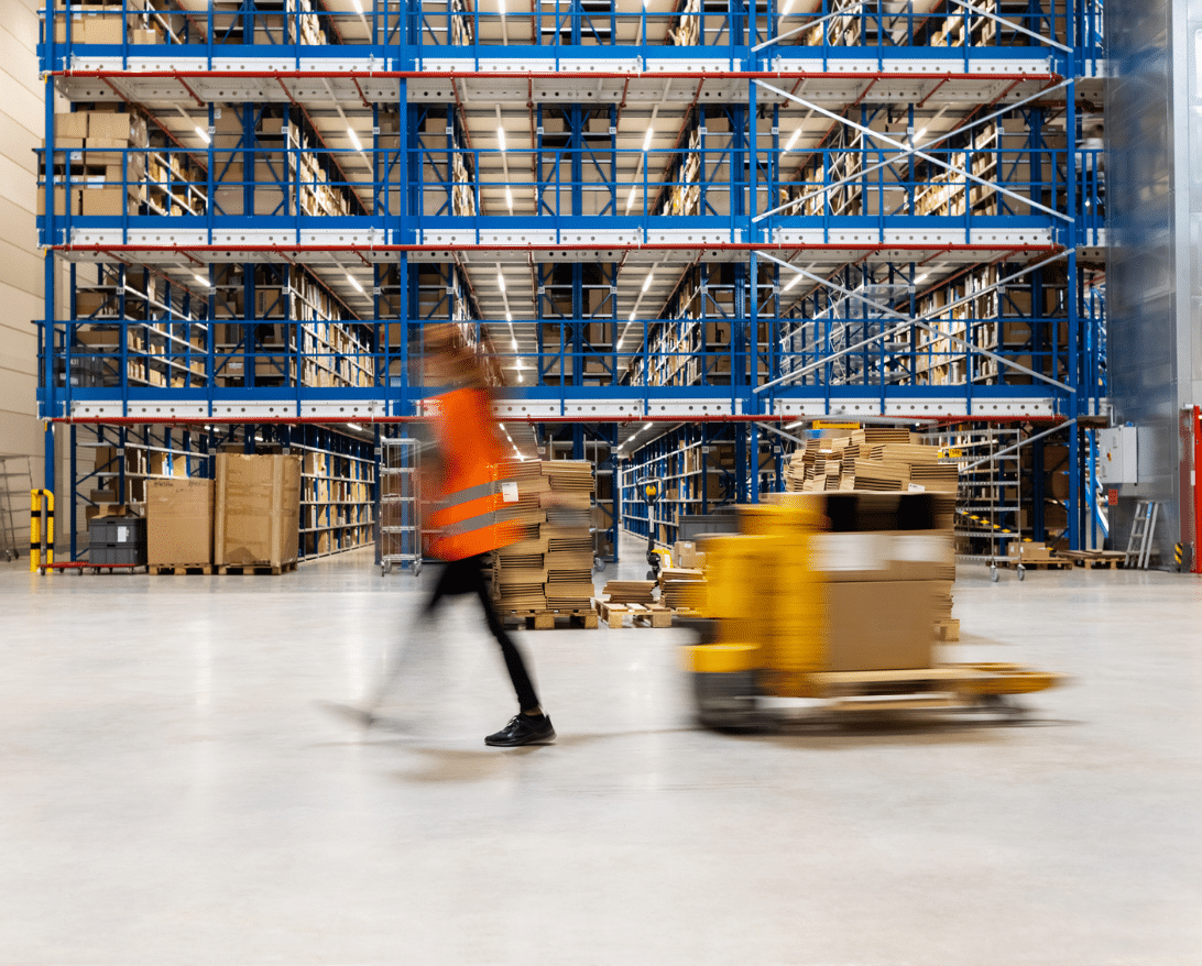 woman walking in a warehouse for restaurant supply chain