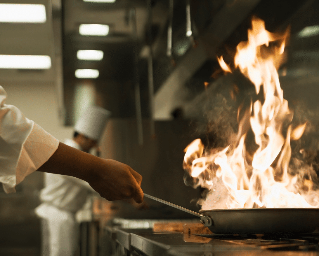 restaurant chef cooking with large fire for restaurant safety