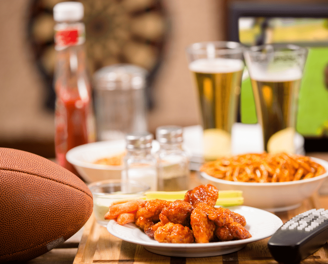 A table with wings, pretzels, and beer for football restaurant delivery.