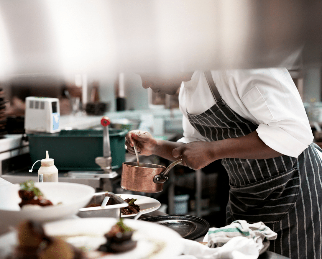 A chef cooks a dish from his catering menu