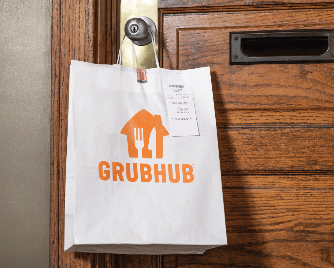 A Grubhub bag sits on a doorstep.