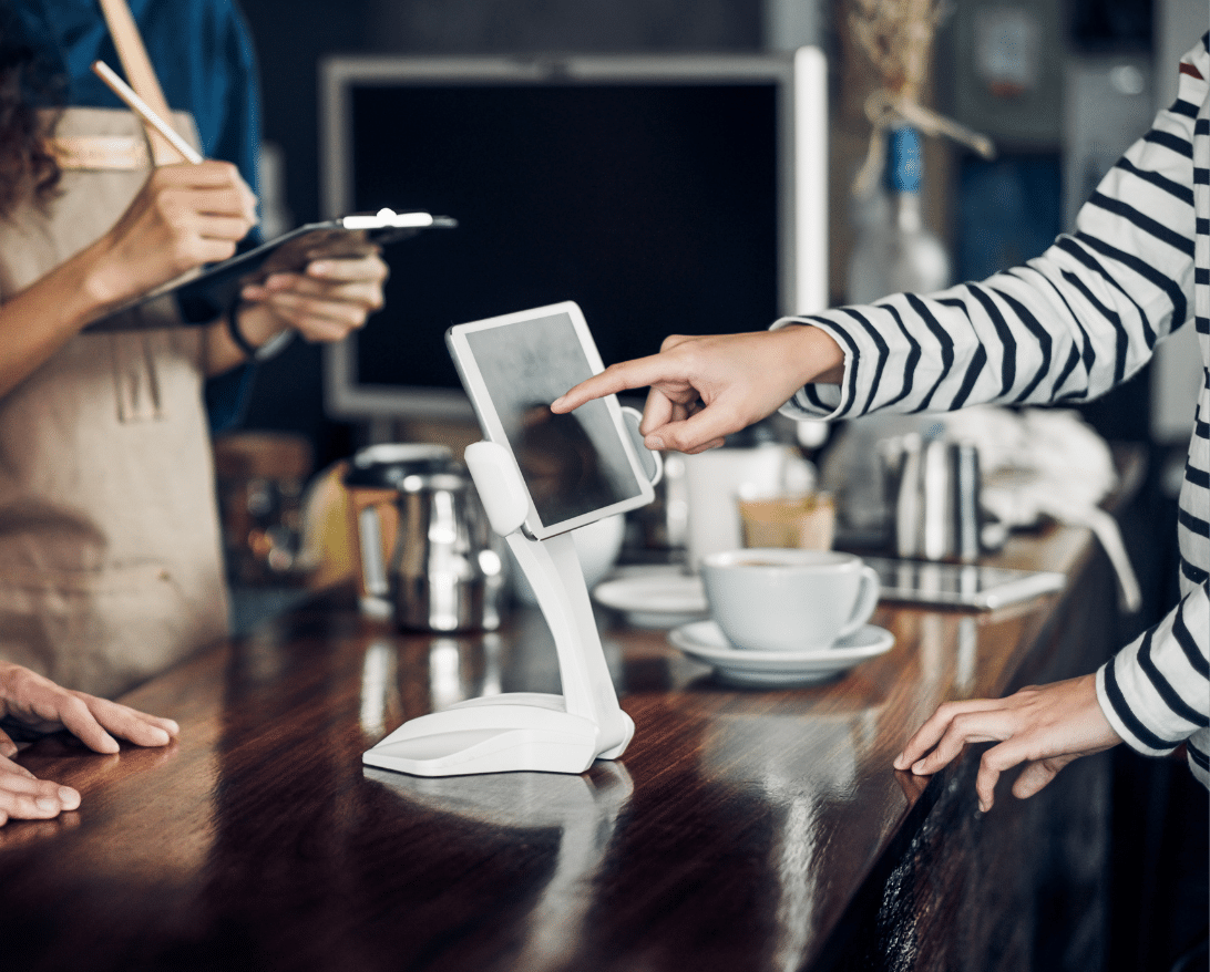 An employee uses a restaurant POS system.