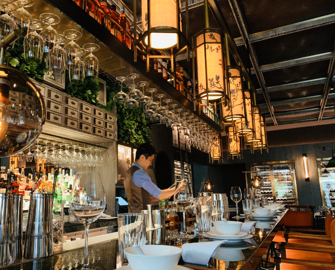 a bartender makes a drink during a restaurant rebranding