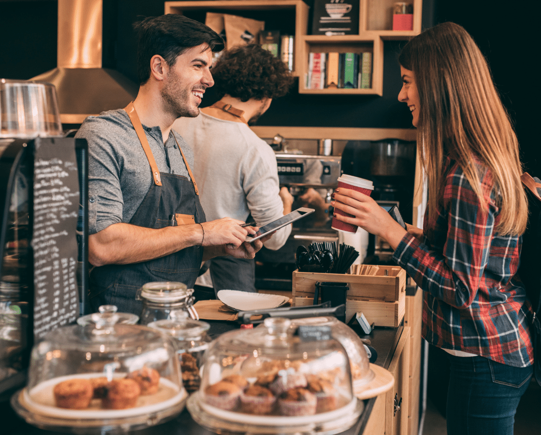 A customer looks at a cafe menu