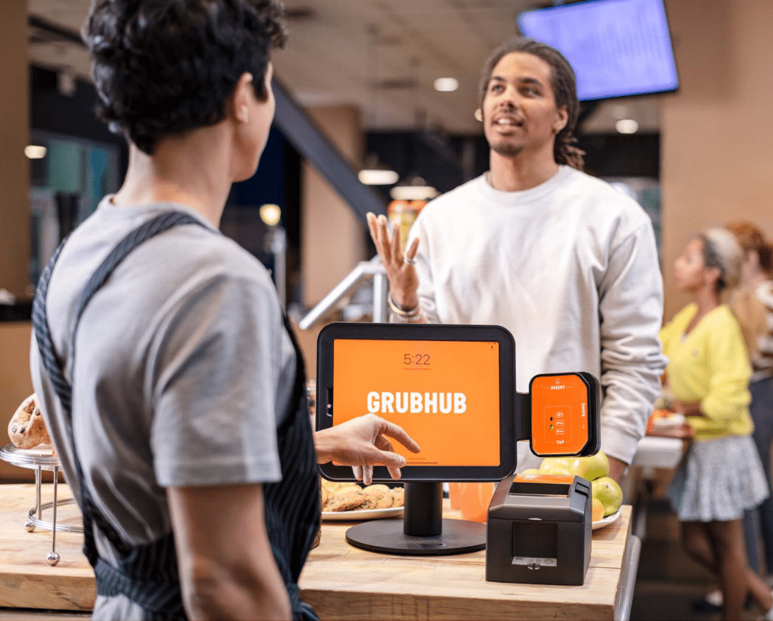 A customer orders from Grubhub at a counter