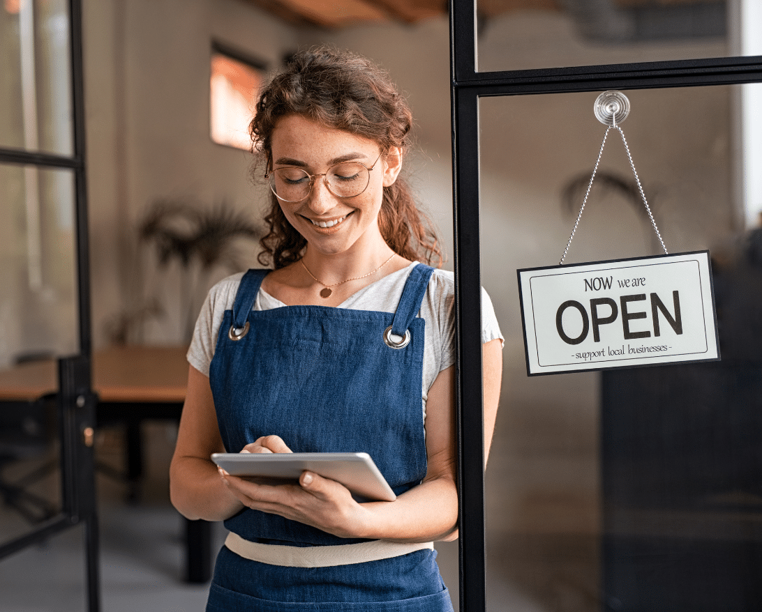 A restaurant owner finds local store marketing ideas on her tablet.