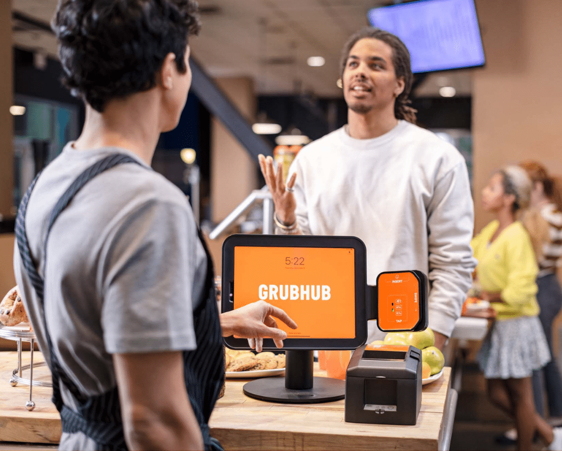 A staff member uses restaurant automation to take an order