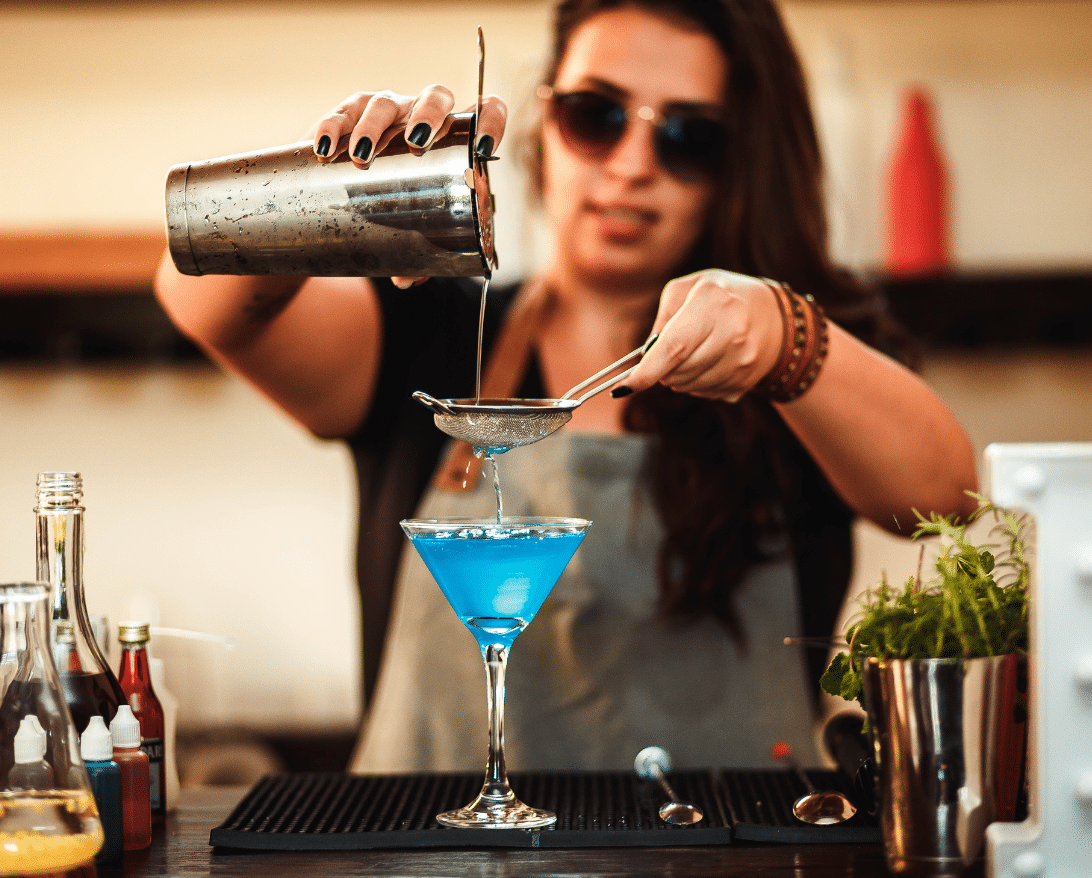 A bartender creates an immersive dining experience at a restaurant
