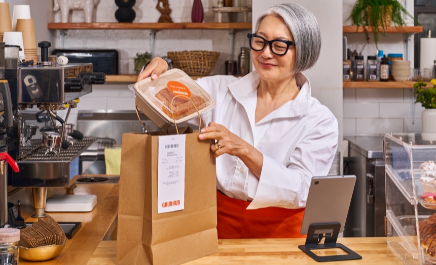 Restaurant merchant packing a Grubhub delivery order
